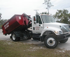 Roll-off container being transported